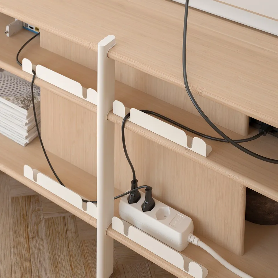 A JÄTTESTA tv stand in bamboo and aluminium with white accents, designed for cable management.