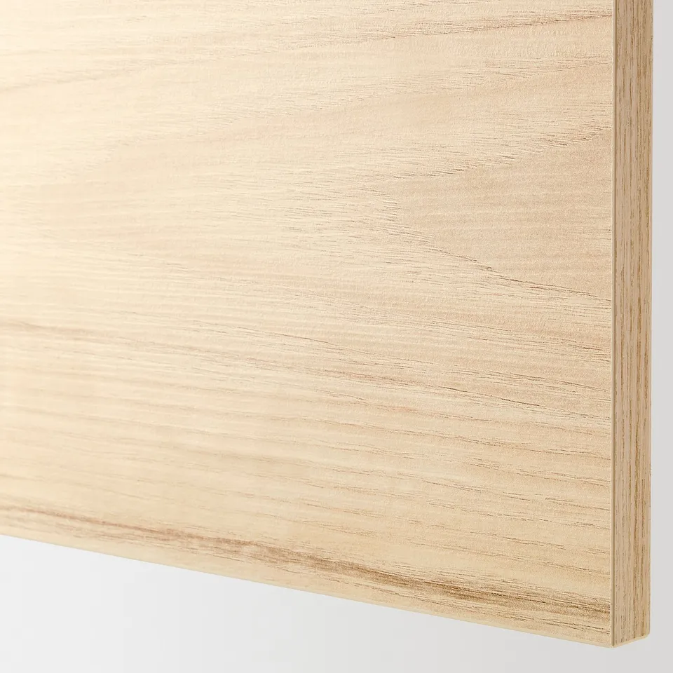 Close-up of light ash wood-patterned kitchen cabinet door, showcasing smooth surface and sturdy edges.