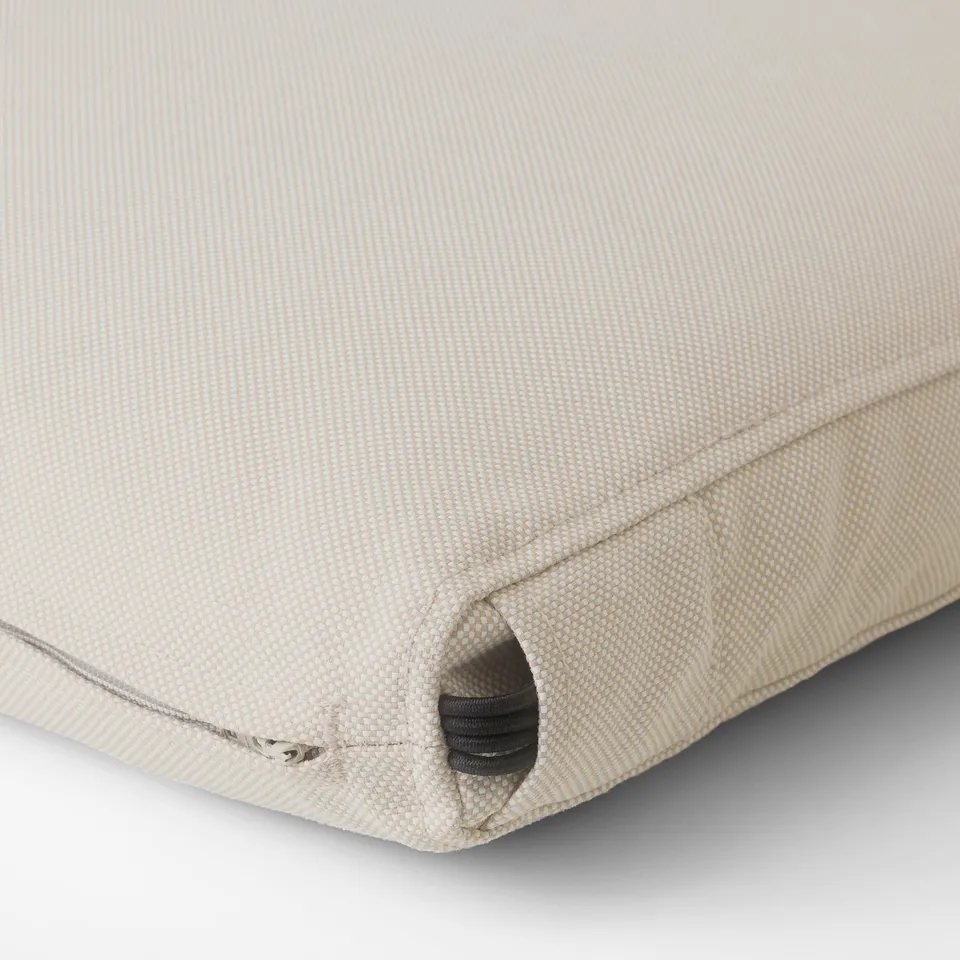 Young cream-colored outdoor cushion with zip, neatly sewn edges, and soft padded core.