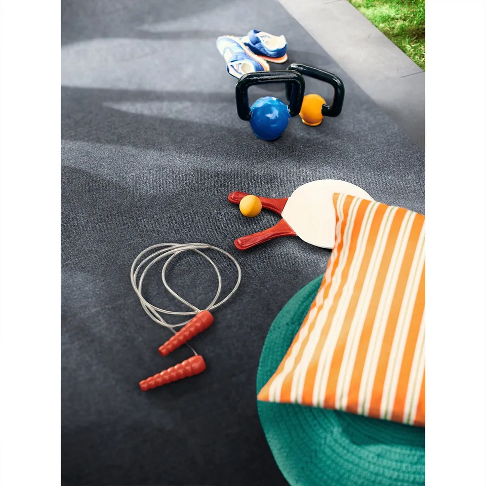 Decking in grey recycled polyester, smaller than sports gear, striped orange cushion.