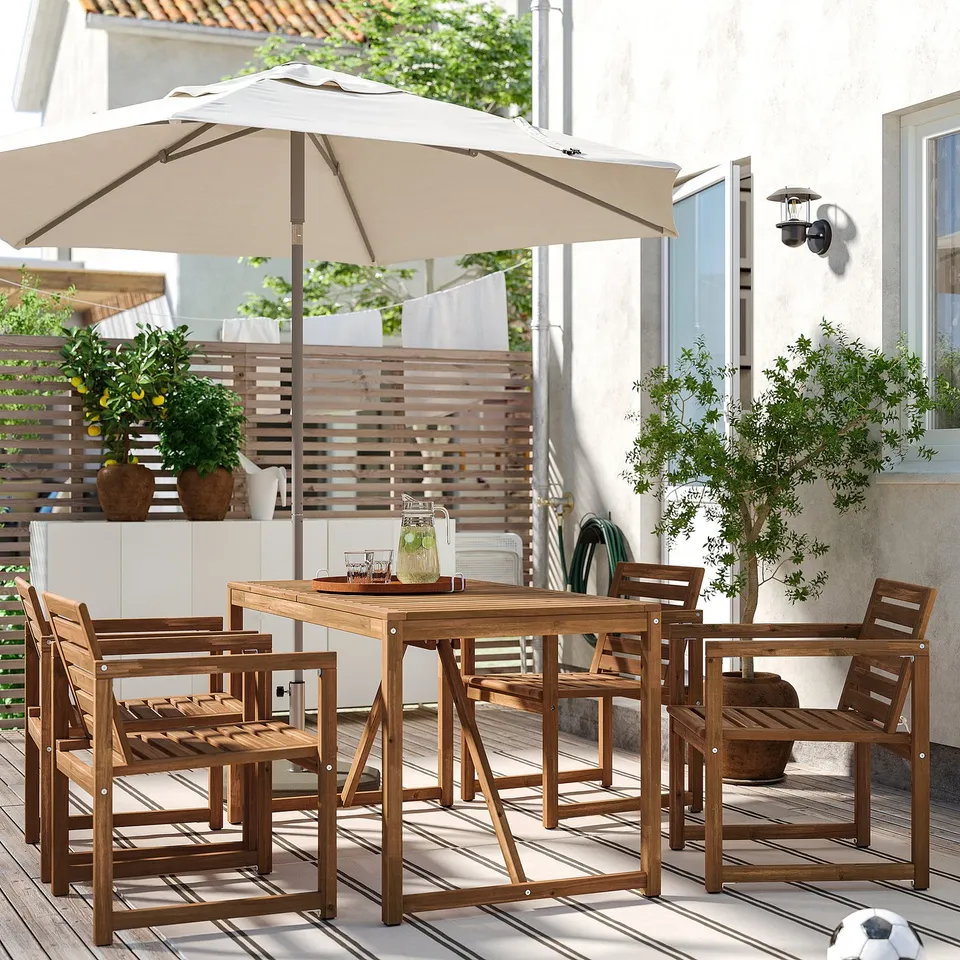 Beige umbrella NÄMMARÖ outdoor dining set with wooden table and chairs.