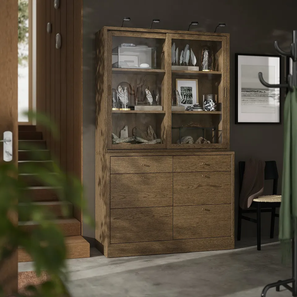 TONSTAD: modern wooden storage. Tall, with shelves & drawers, against wall. Displayed items & framed art nearby. Blends classic & contemporary.