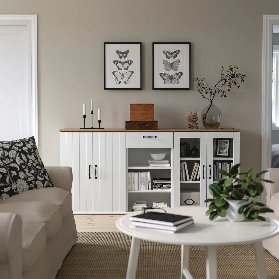Modern living room with SKRUVBY sideboard, butterfly prints, beige sofa, plant table, and rug.