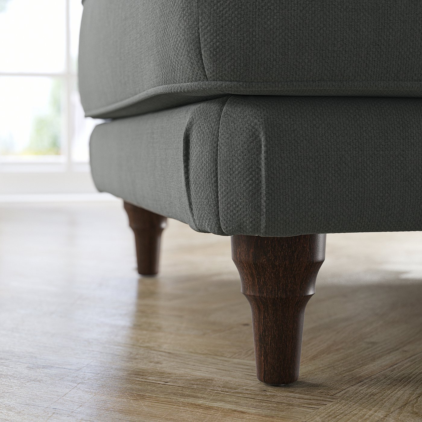 Close-up of grey ESSEBODA footstool on wood floor. Dark wood legs, cushioned seat.