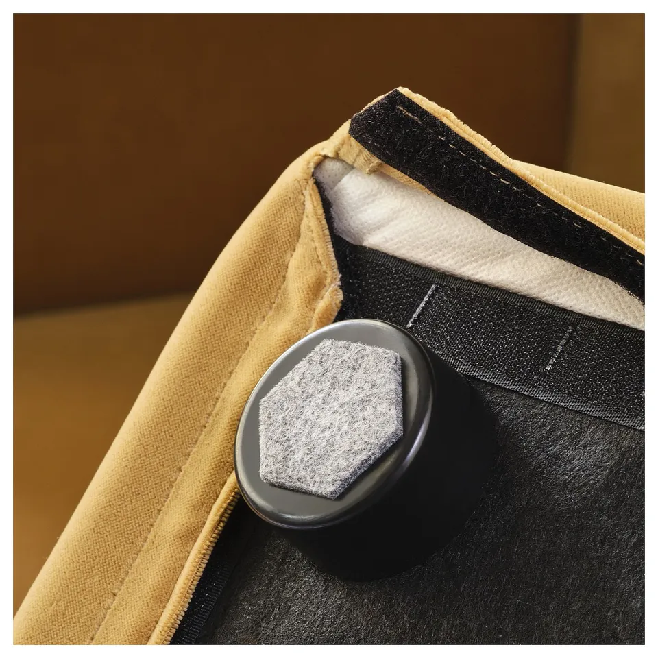 Close-up of high-quality cushion, featuring durable fastener and textured fabric.