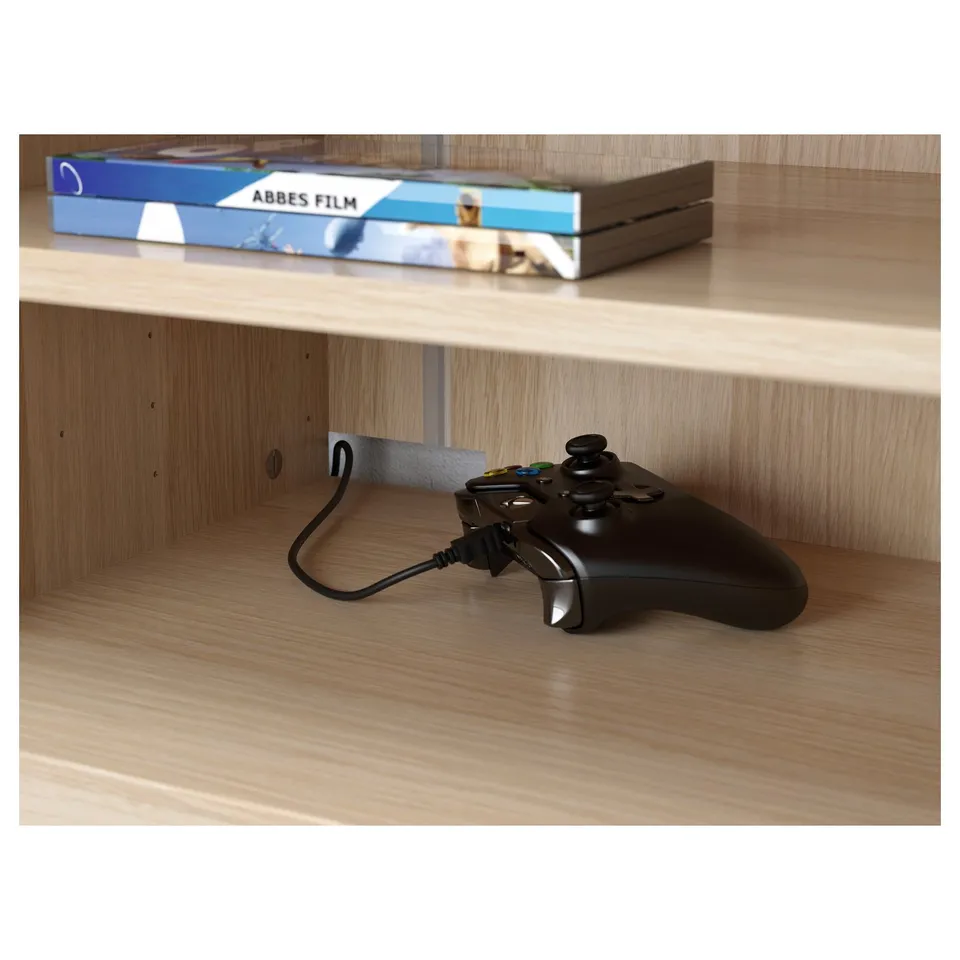 Wooden shelves with a black gaming controller and a box labelled abbes film on top.