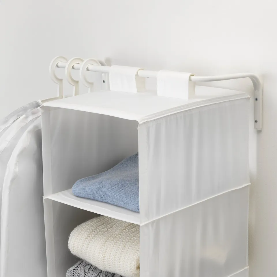 White wall-mounted closet organiser with adjustable width, holding folded clothes and towels. Hanging rod above for additional storage.