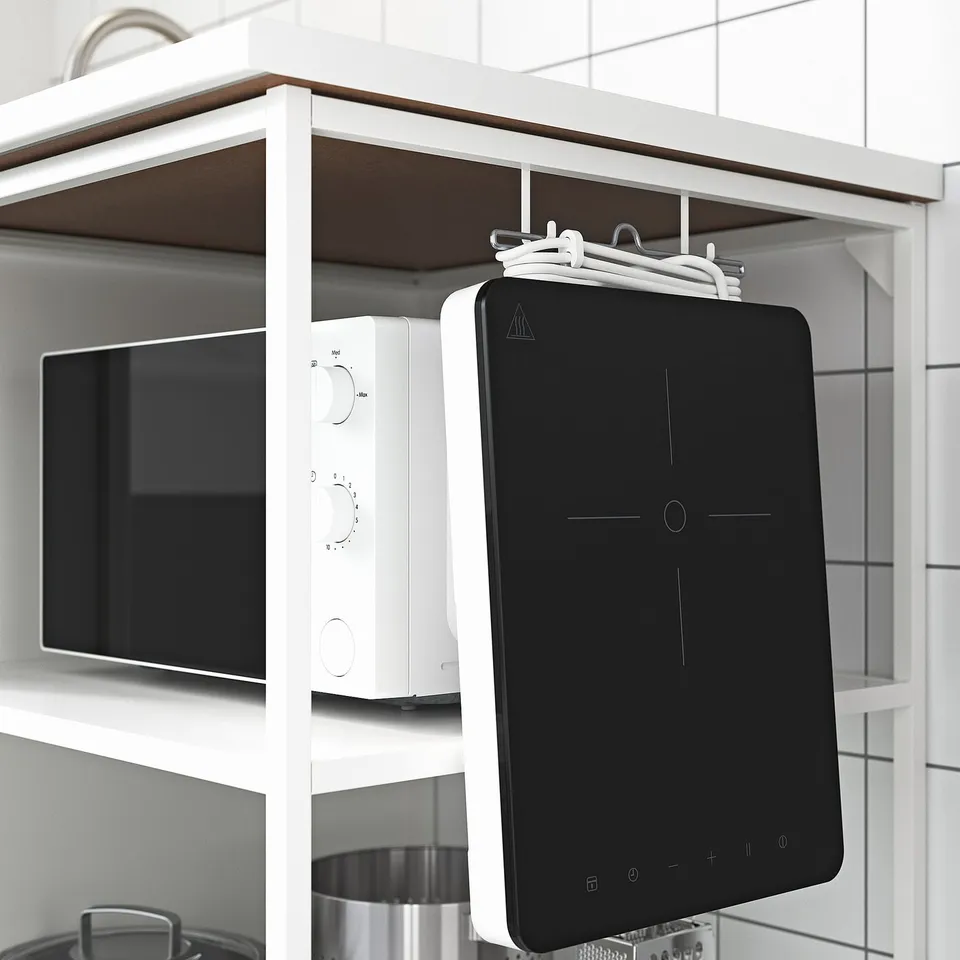 Kitchen shelf with microwave, tablet, open storage.