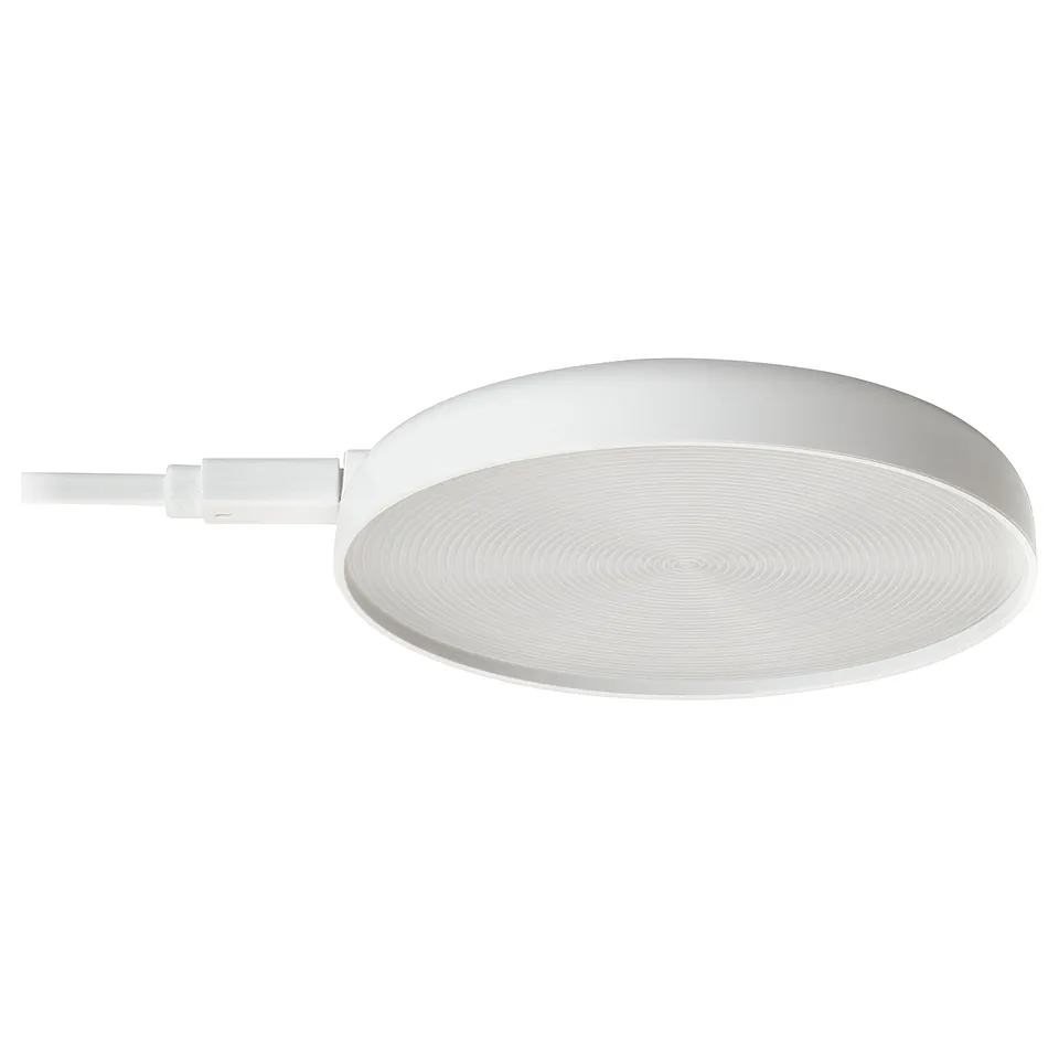 A white STRIMSÄV spotlight for illuminating cabinets. Its circular with a smooth edge and a spiral pattern. Includes a cable connexion.