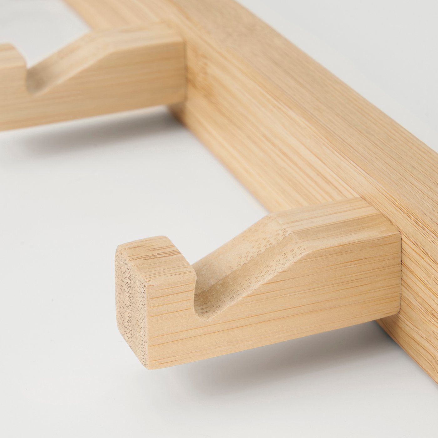 Wooden hanger detail, showcasing smooth finish & natural grain.