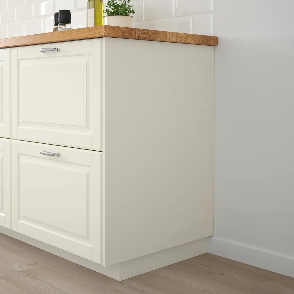 White FÖRBÄTTRA kitchen cabinet with wooden countertop and floor; simple, rectangular design.