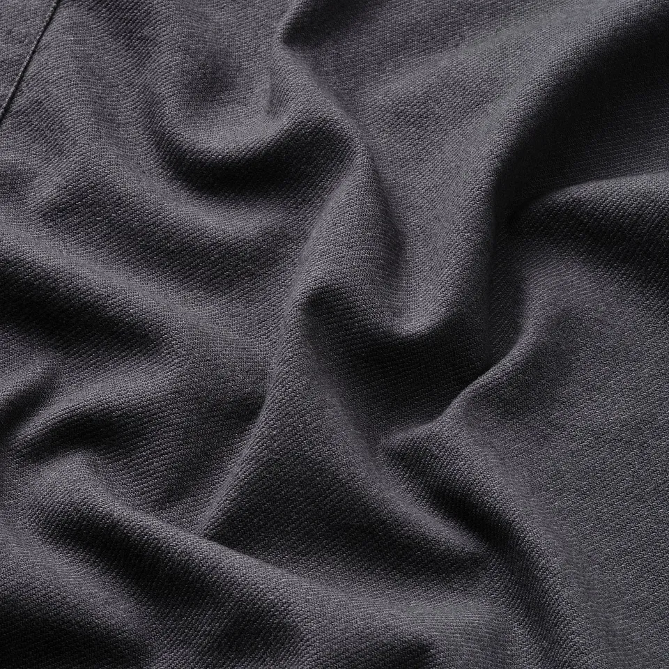 Wrinkled dark apron fabric, quality cotton blend, professionally crafted, durable texture visible.