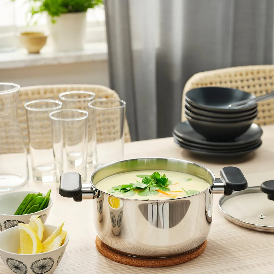 Kitchen table with soup and glasses.