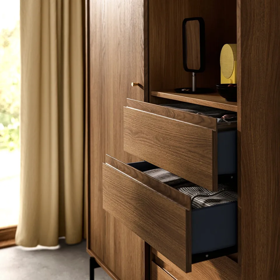 Wooden wardrobe with sliding door and open drawers. Walnut tone, blue interior, and black metal legs.