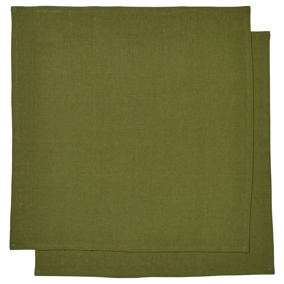 Two green linen rectangular napkins, neatly folded and stacked. Part of the STOCKHOLM 2025 collection.