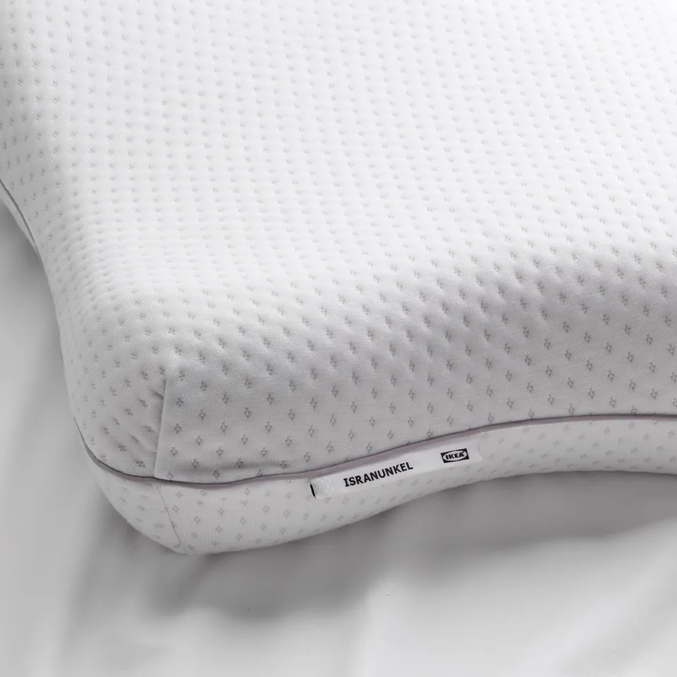 White ergonomic memory foam pillow in butterfly shape, designed for all sleeping positions. Ikea ISRANUNKEL text visible.