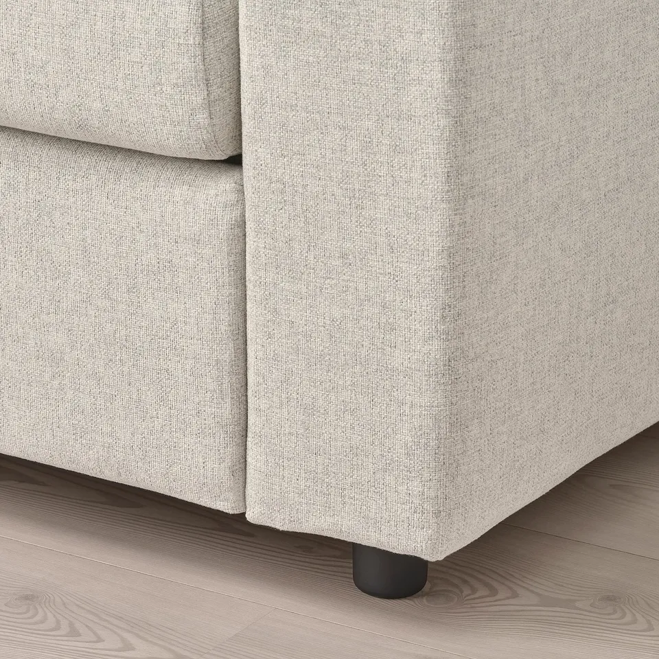 Close-up of beige VIMLE sofas plush, upholstered cushion on wooden floor.