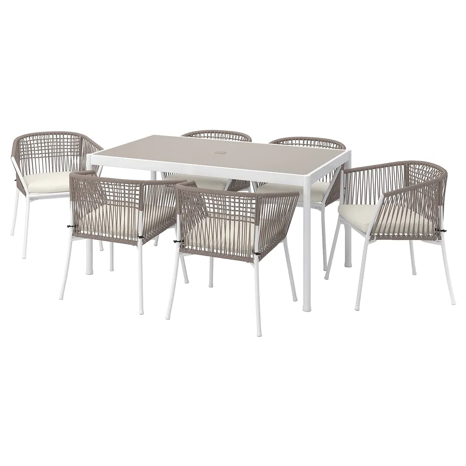 Modern outdoor dining set with white metal table and four matching beige wicker chairs, perfect for patios or gardens.