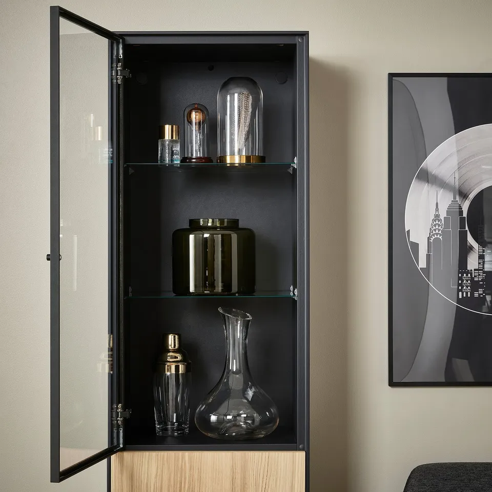 Black glass cabinet with oak base; displays bottles and vases. Properly secured to wall, adjustable shelves.