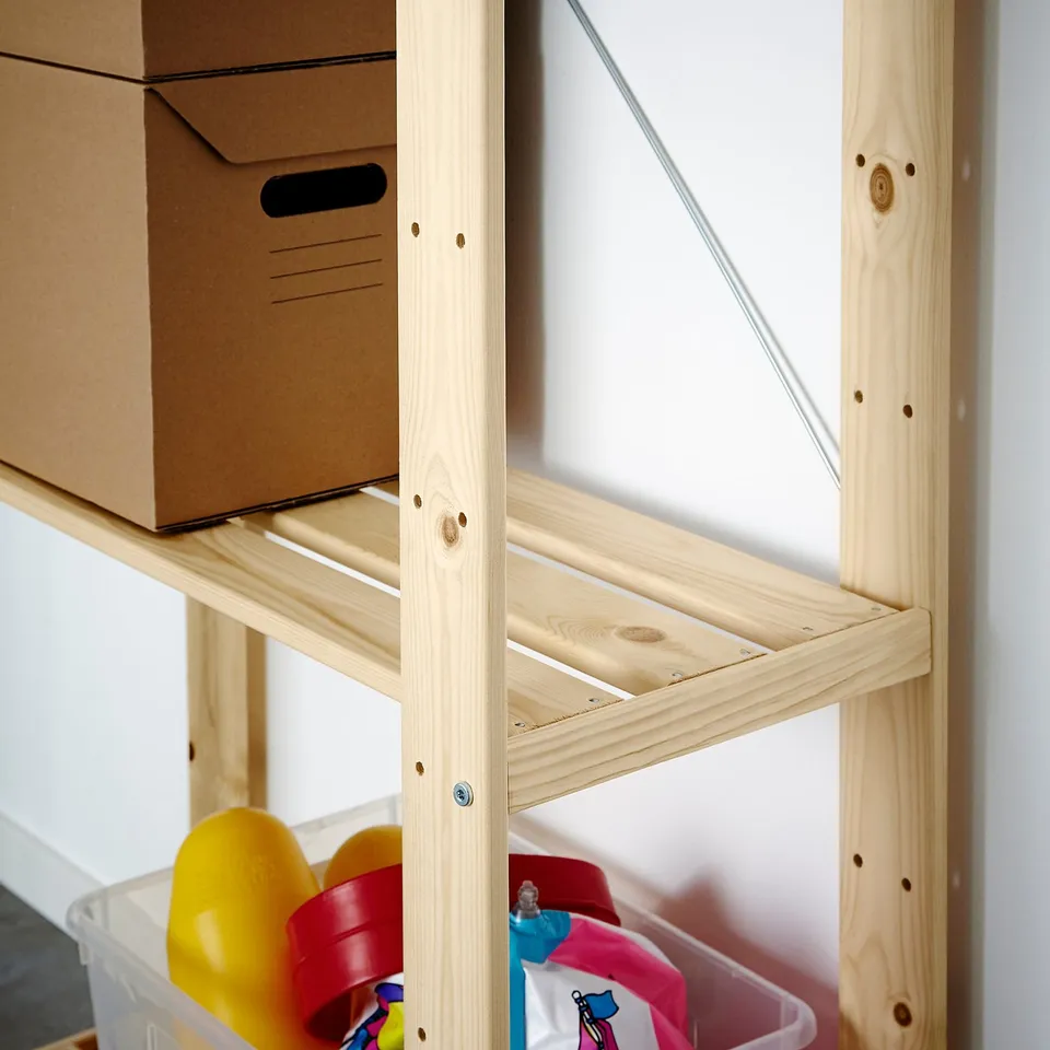 Wooden storage unit with cardboard boxes and colourful plastic bins.