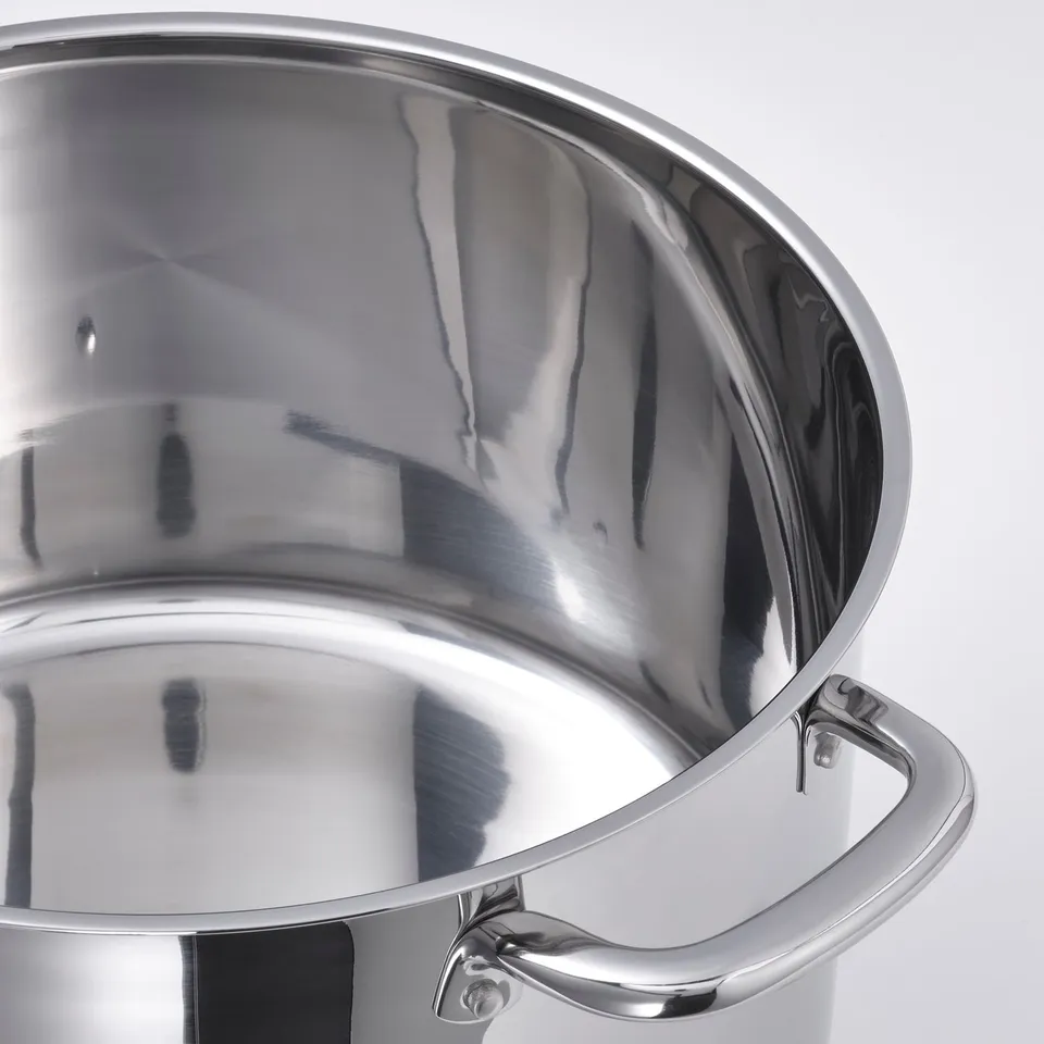 Stainless steel pots polished, reflective interior quality craftsmanship. Two sturdy handles visible.