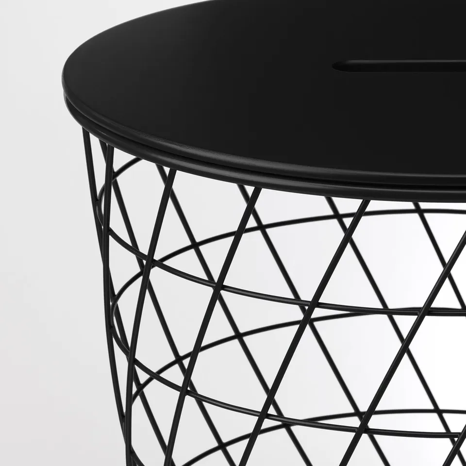 Modern black side table with a sleek, round top and intricate, geometric wire base.