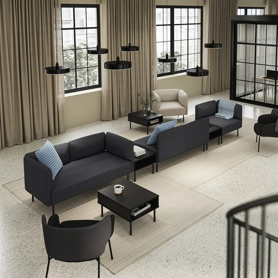 Modern living area with LILLEHEM sofa, black coffee table, black armchair, beige curtains, and black pendant lights.
