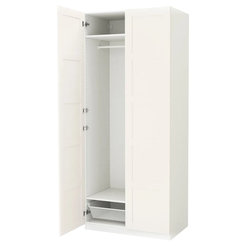 White PAX wardrobe, open doors revealing shelves and mesh basket.