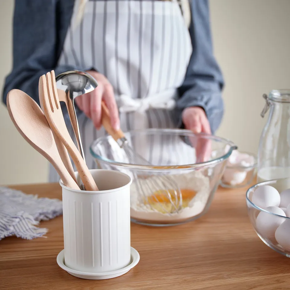 Person mixing ingredients in bowl with whisk