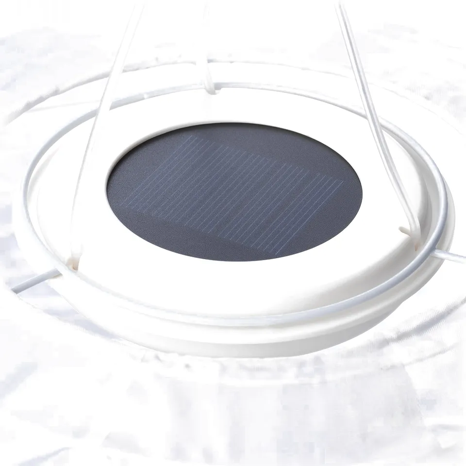A solar-powered pendant lamp, SOLVINDEN, hangs from a cord. Its dark shade contrasts with its white frame, indicating quality and eco-friendliness.