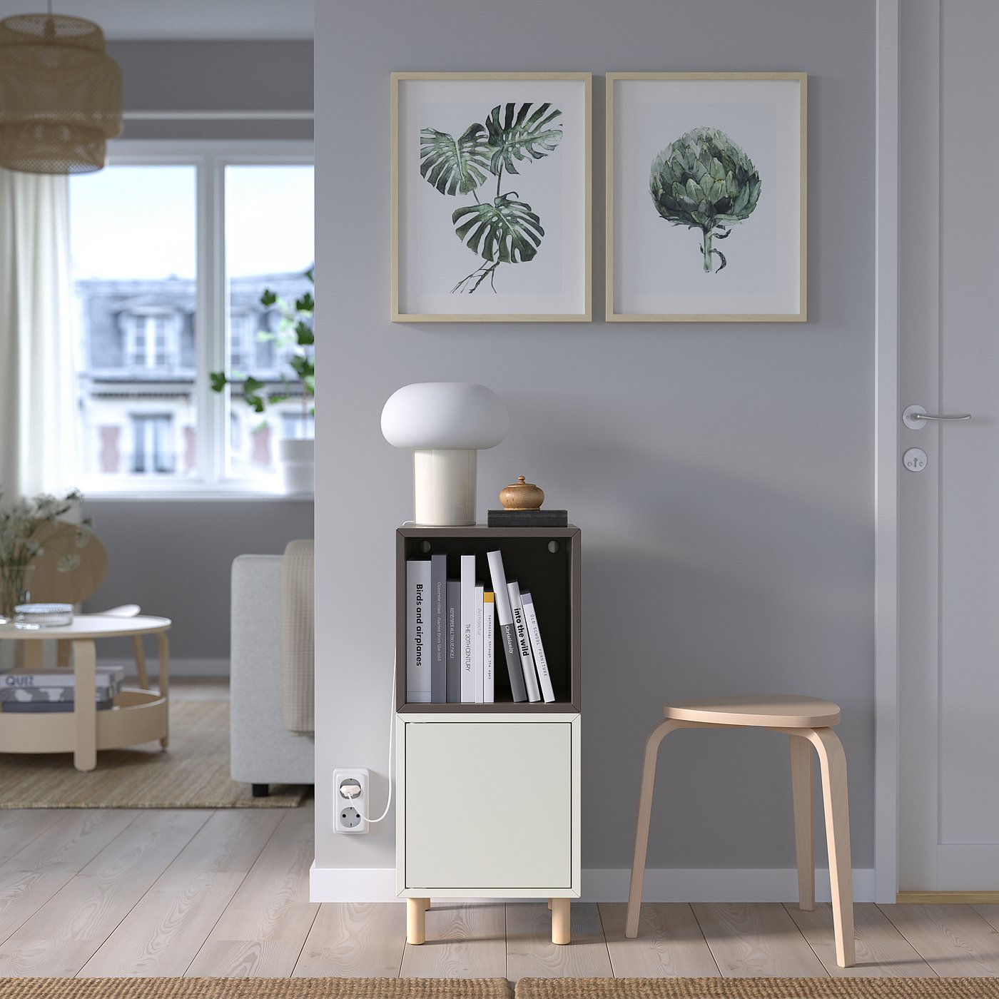 Modern living room with EKET storage, lamp, and plant prints