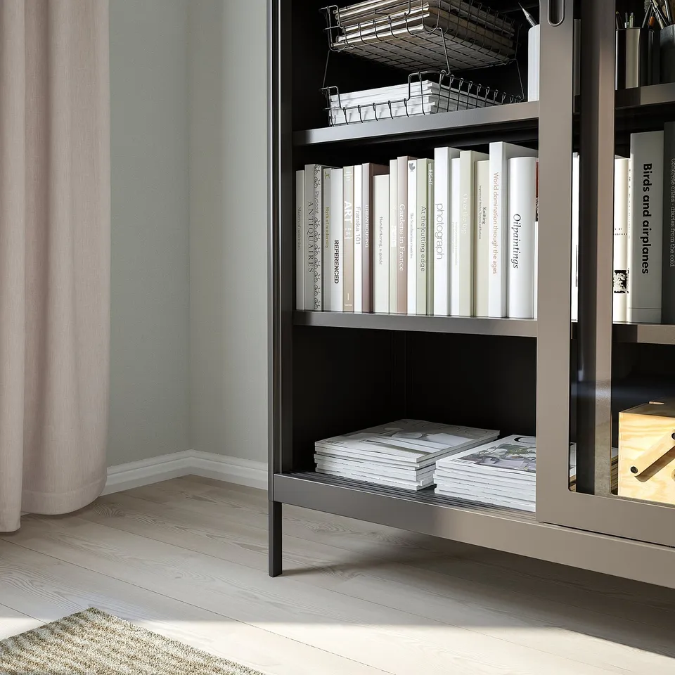 Bookshelf with sliding glass doors books, keeping dust away. Tempered glass and metal design offers durability and an airy feel.
