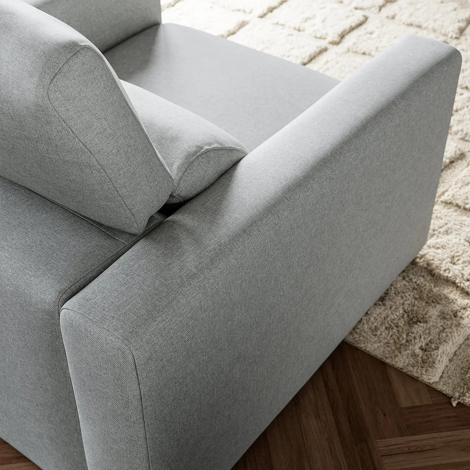 Modern light grey armchair, stylish & comfortable, clean lines, supportive cushions.