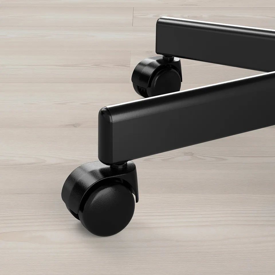 Black office chair casters on hardwood floor, demonstrating high-quality design and smooth mobility.