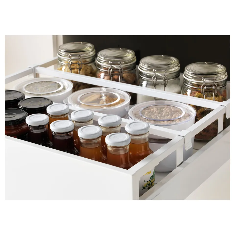 A modern kitchen drawer filled with jars and containers, showcasing organised storage with adjustable shelves and a self-closing mechanism.
