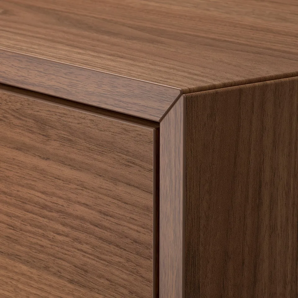 Close-up of high-quality wooden cabinet edge. Sleek, polished finish shows fine wood grain and craftsmanship.
