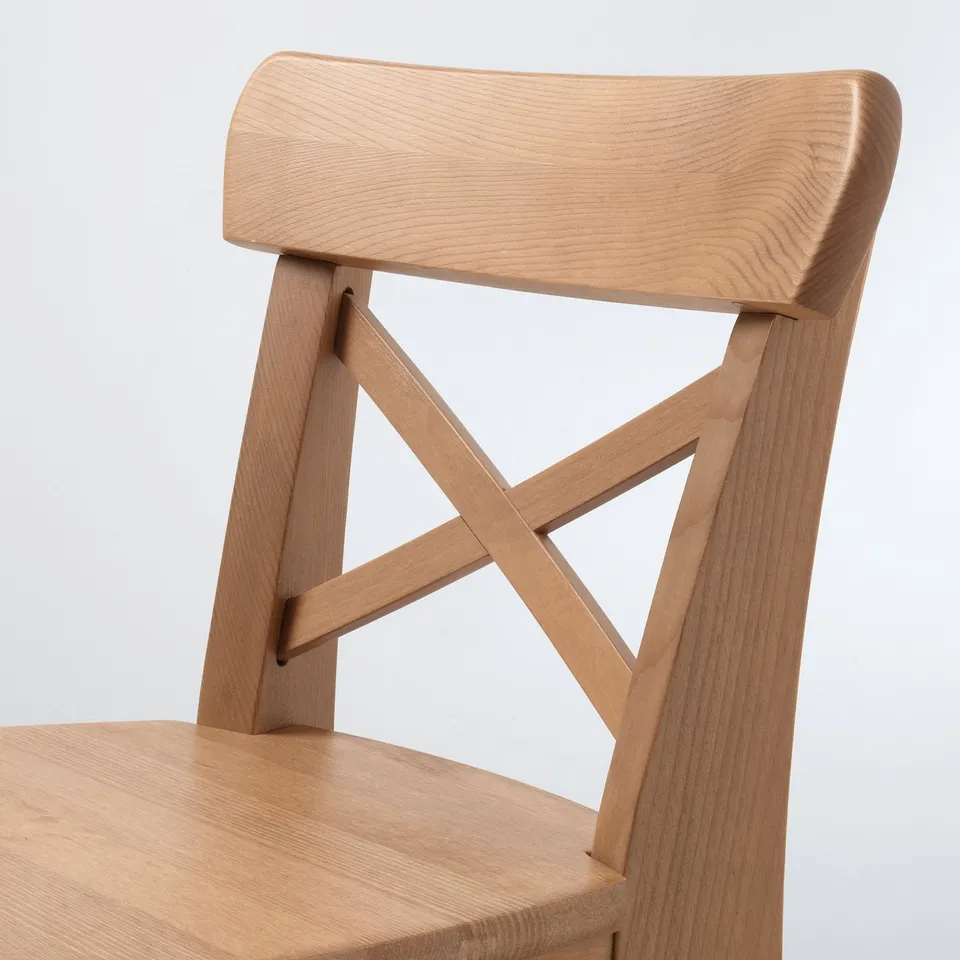 Well-crafted wooden chair, light finish. Sturdy design with elegant, curved backrest. Suitable for children.