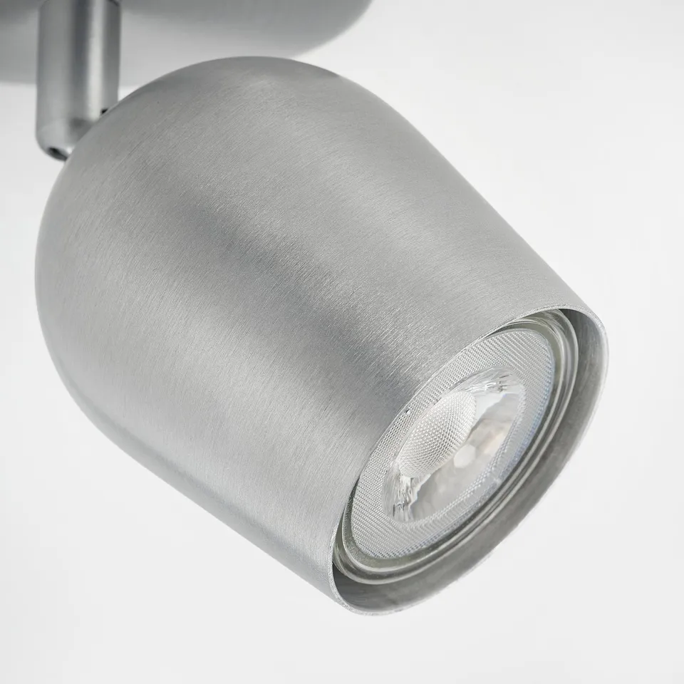 Silver adjustable spotlight with metallic finish and directed light beam.
