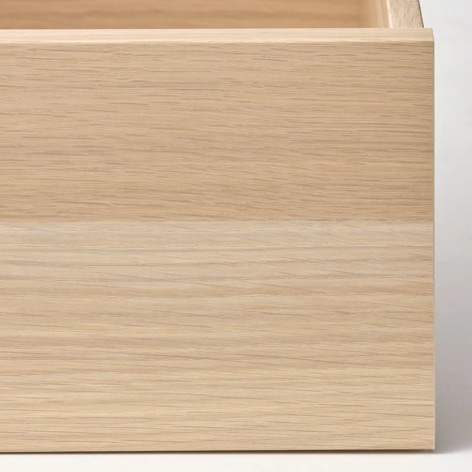 Light wooden drawer close-up, smoothly textured, showing craftsmanship and polished finish.