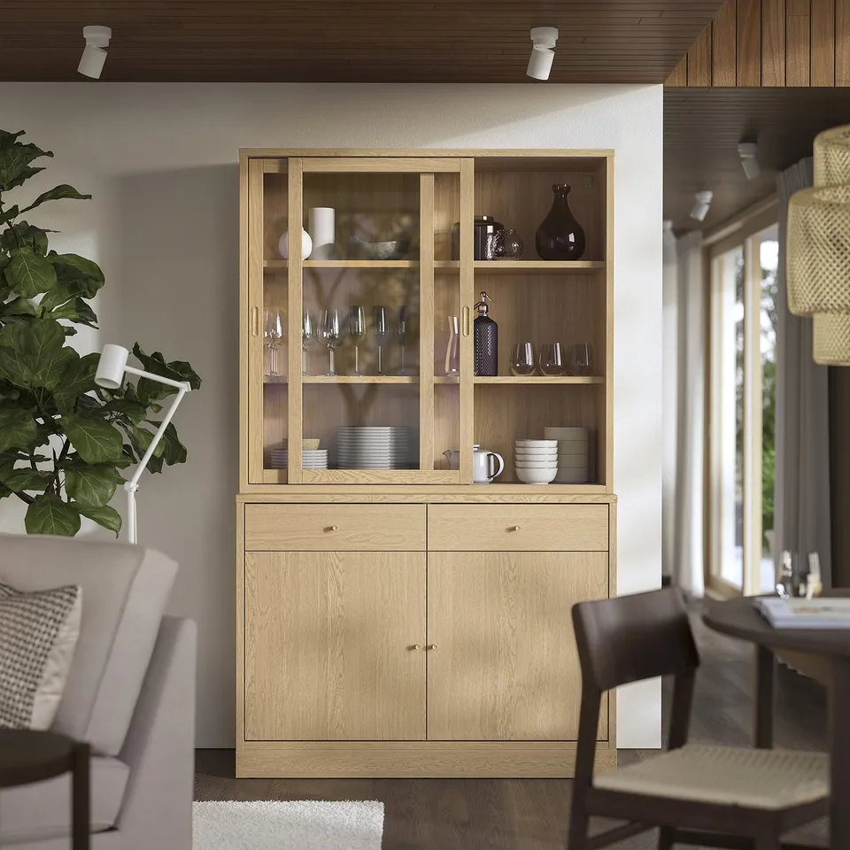 Modern dining room with TONSTAD cabinet displaying dishes, sleek and minimalist.