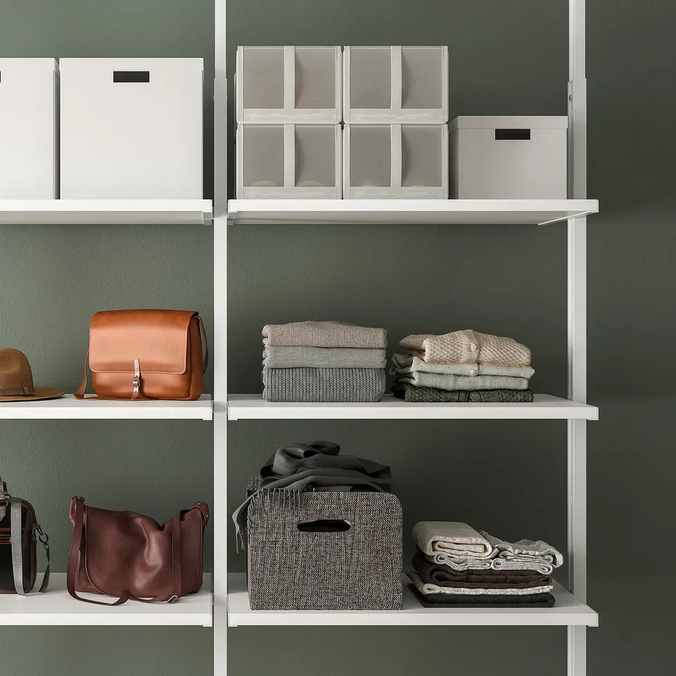 Shelving unit with folded clothes and handbags; adjustable shelves and space-efficient storage.