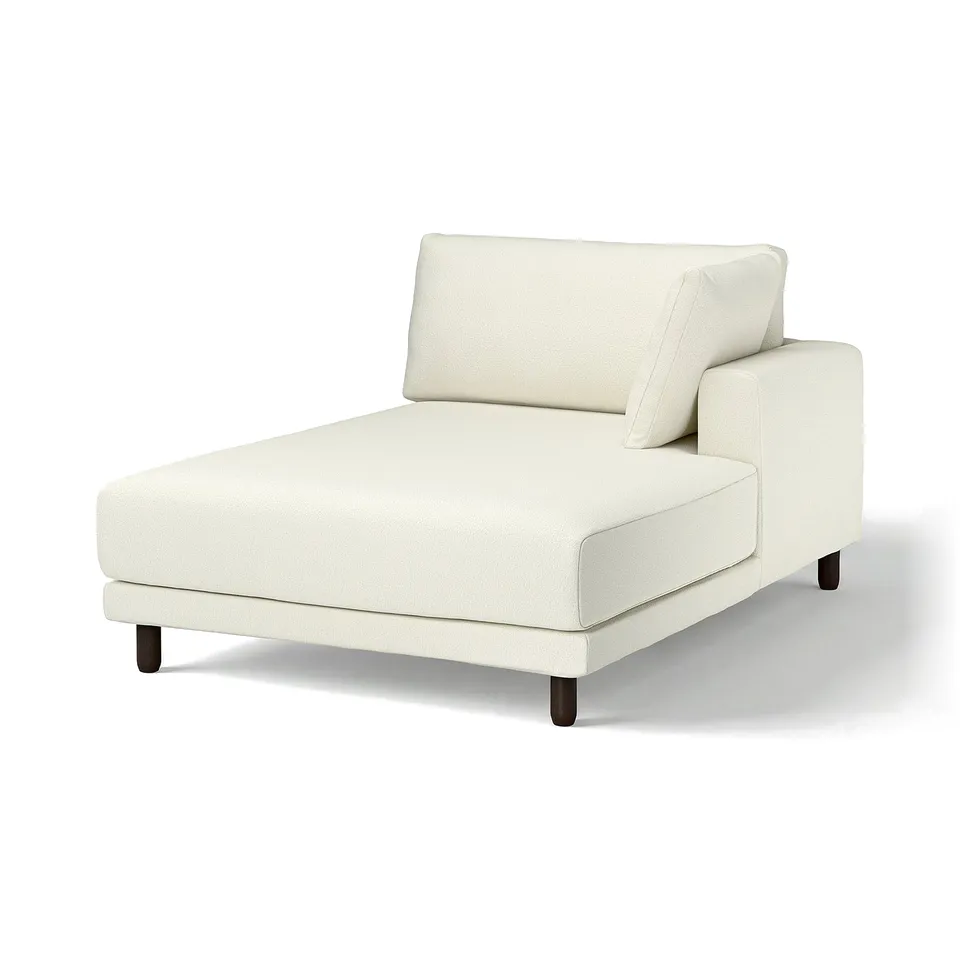 The UPPÅKRA chaise lounge is a minimalist white fabric chair with wooden legs, offering a sleek design for comfort.