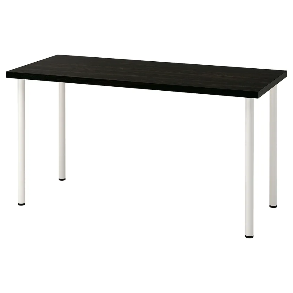 A LAGKAPTEN desk with a black top and white legs. Its modern and sturdy.