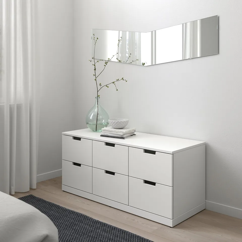 NORDLI chest with 6 drawers, mirror, vase, books, bowl.