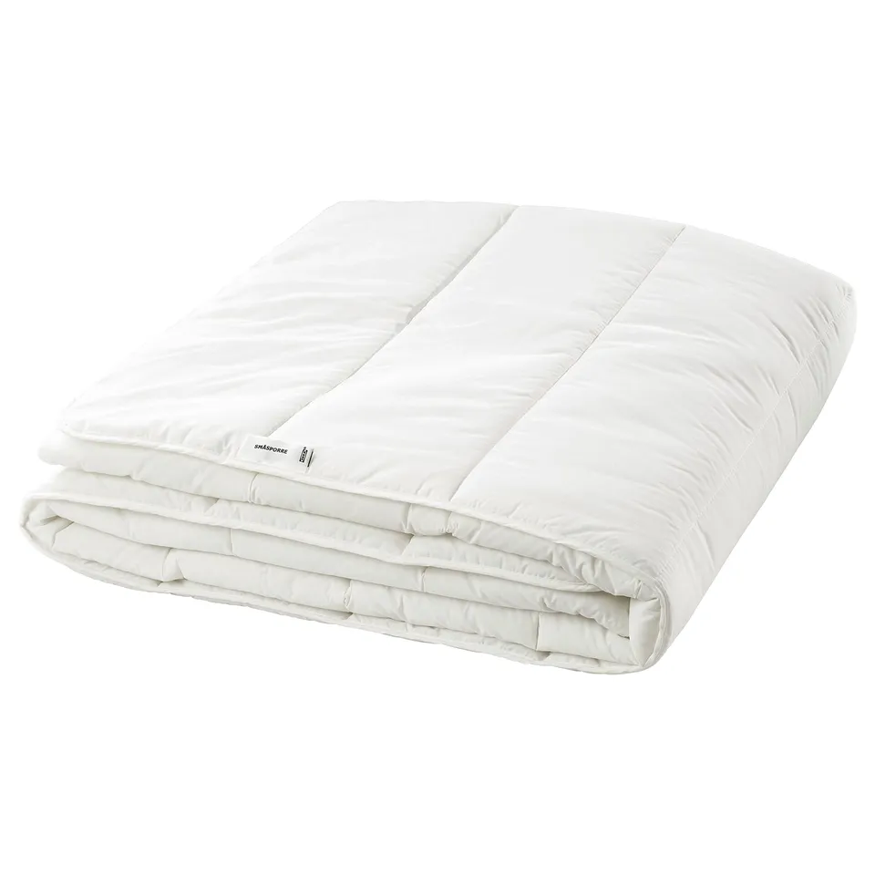 Clean white folded comforter, smooth rectangular shape, simple design.