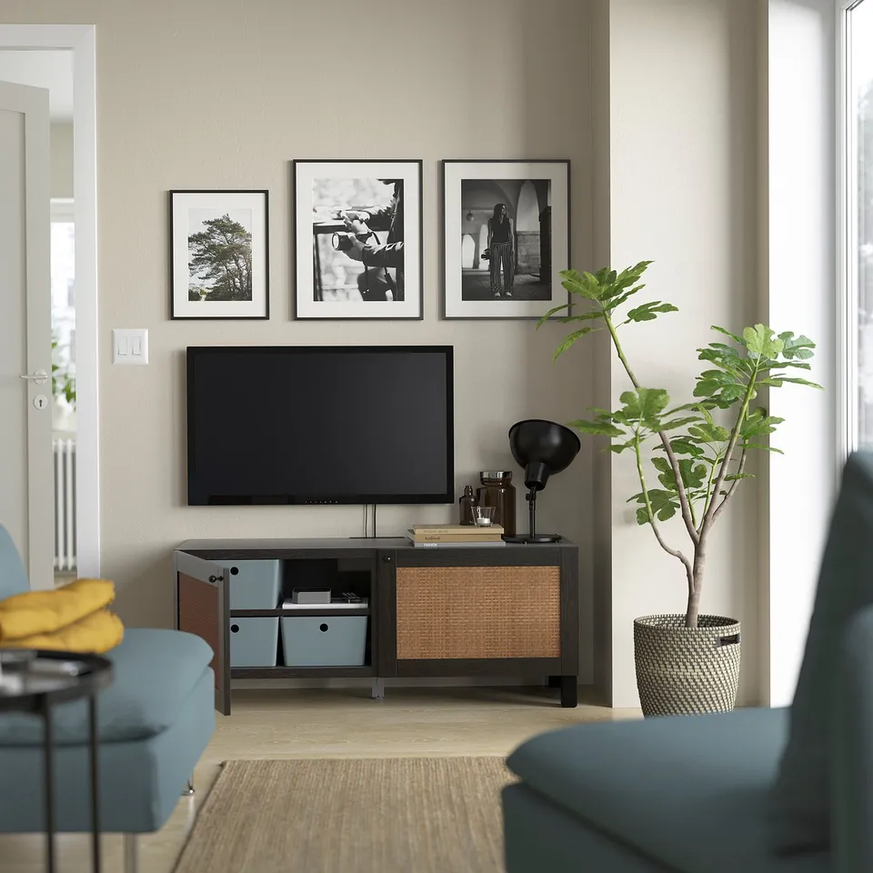 Modern living room with BESTÅ tv unit, plant, and armchair.