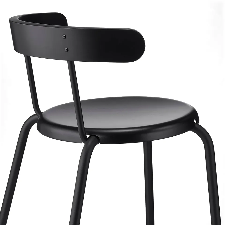 Modern black chair with rounded back and seat, metal legs, easy to clean and stack.