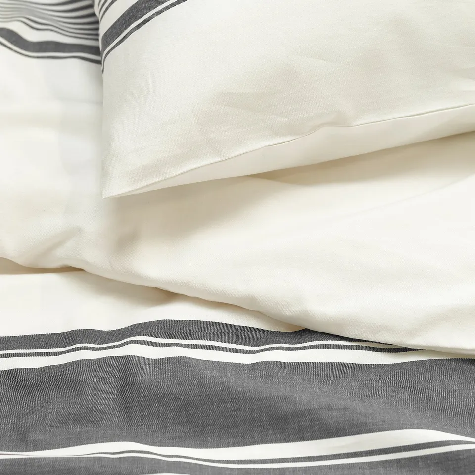 Close-up of JÄTTEFRÄKEN bedding showcasing soft, crease-resistant, high-quality cotton stripes and texture.