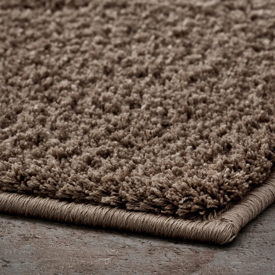 Thick, plush bath mat with dense, soft pile; latex backing.