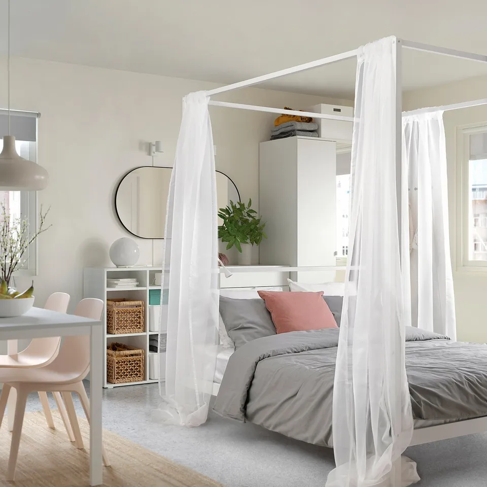 VITARNA four-poster bed in minimalist room, white curtains, large and sturdy.